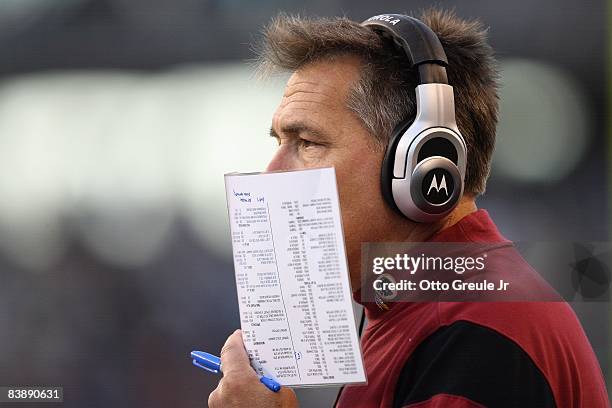 Head coach Jim Zorn of the Washington Redskins calls a play from the playbook during the game against the Seattle Seahawks on November 23, 2008 at...