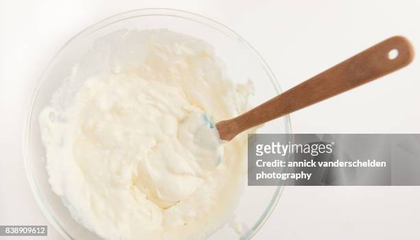 glass bowl with whipped double cream, chunks of ricotta cheese and melted white chocolate. - ricotta cheese stock pictures, royalty-free photos & images