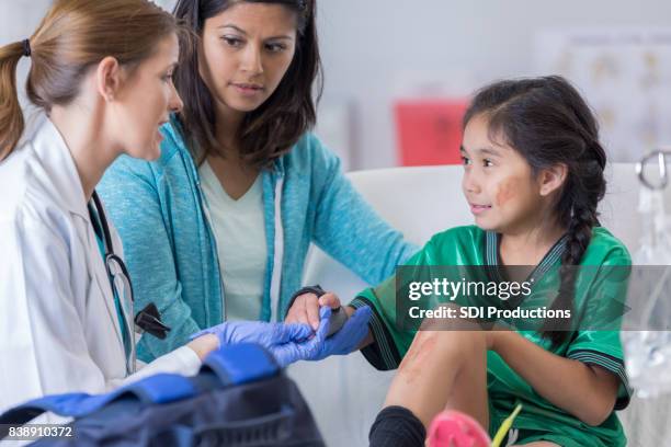 young injured soccer player receives medical attention - injured hand stock pictures, royalty-free photos & images