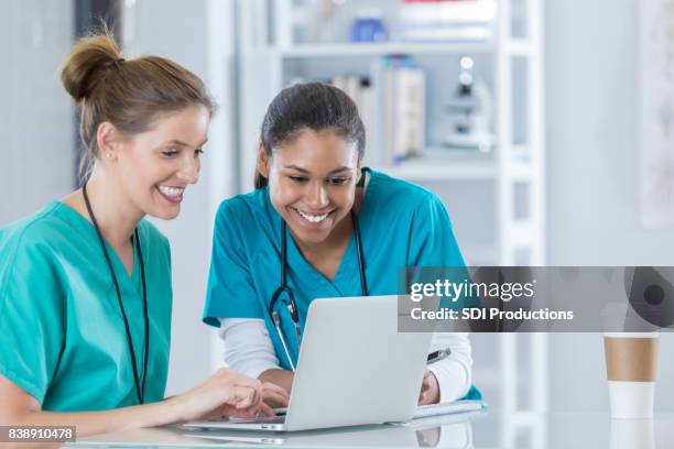 nursing students work on research project together - doctor using laptop stock pictures, royalty-free photos & images