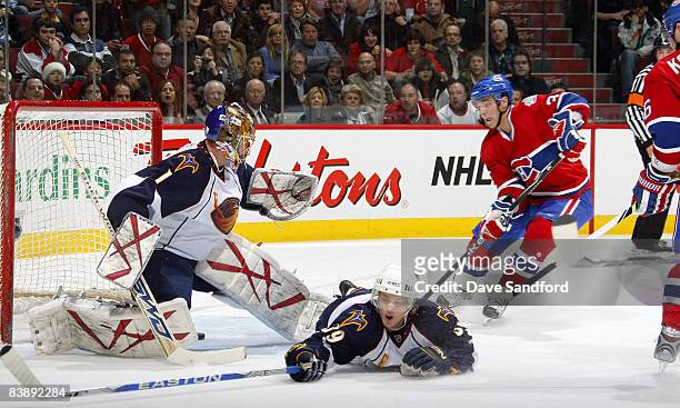 Matt D'Agostini of the Montreal Canadiens looks on as Johan Hedberg of the Atlanta Thrashers is beat on a shot by Sergei Kostitsyn of the Montreal...