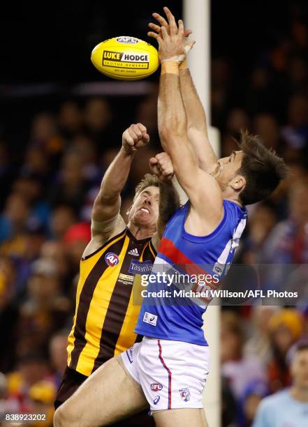 Tom Campbell of the Bulldogs and Kaiden Brand of the Hawks compete for the ball during the 2017 AFL round 23 match between the Hawthorn Hawks and the...