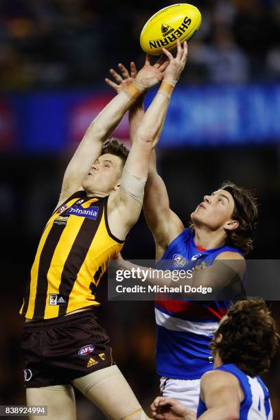 Taylor Duryea of the Hawks marks the ball against Patrick Lipinski of the Bulldogs during round 23 AFL match between the Hawthorn Hawks and the...