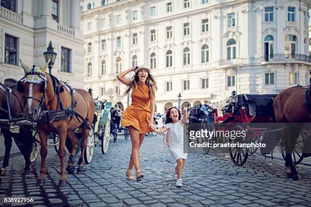 mother and daughter is making fun on the street - austria stock pictures, royalty-free photos & images