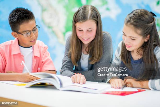 reading a textbook - pre adolescent child stock pictures, royalty-free photos & images