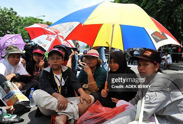 People whose houses were submerged by a mud volcano that erupted after drilling for gas, hold a protest in front of Indonesian presidential palace in...