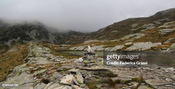 panoramic view of variola lake with rock cairn in the foreground - gloomy swamp stock pictures, royalty-free photos & images