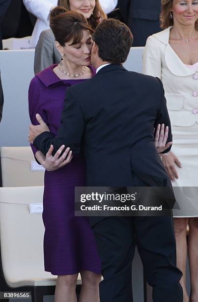 French President Nicolas Sarkozy kisses his wife Carla Bruni-Sarkozy prior to the start of the ceremony of the Bastille Day, on July 14, 2008 in...