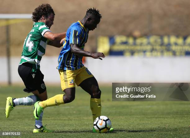 Real SC midfielder Brash from Guinea Bissau with Sporting CP B midfielder Rafael Barbosa in action during the Segunda Liga match between Real SC and...