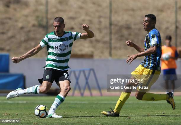 Sporting CP B defender Merih Demiral with Real SC forward Carlos Vinícius from Brazil in action during the Segunda Liga match between Real SC and...