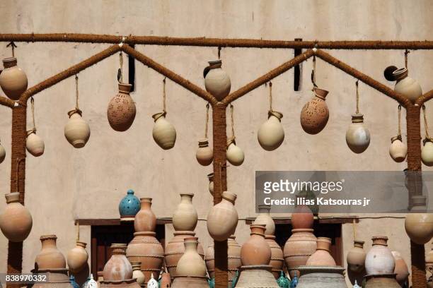 traditional pottery in a souk market in nizwa, oman - sand stone wall stock pictures, royalty-free photos & images
