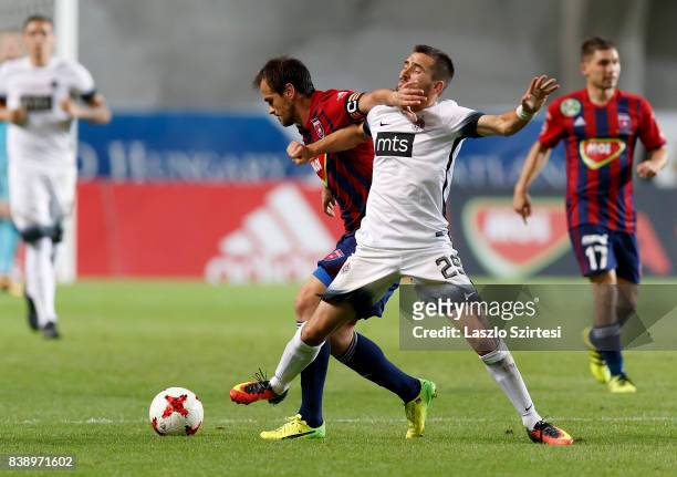 Danko Lazovic of Videoton FC fights for the ball with Milan Radin of FK Partizan during the UEFA Europa League Play-offs 2nd Leg match between...