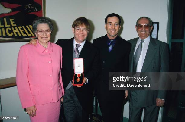 Elton John with his mother Sheila Farebrother, his stepfather and his partner David Furnish, after receiving his knighthood in London, 24th February...