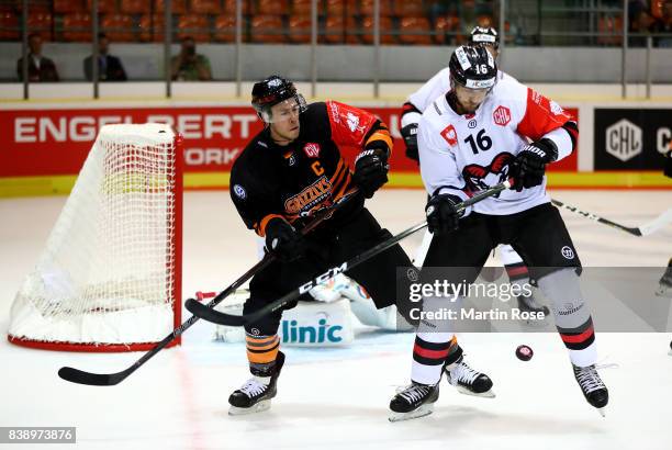 Tyler Haskins of Wolfsburg and Adam Sedlak of Bystrica battle for the puck during the Champions Hockey League match between Grizzlys Wolfsburg and...