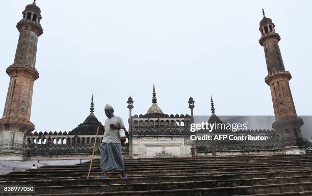 An Indian man walks down the stairs next to the mosque at the Bara Imambara, a colossal imambara complex in Lucknow, northern India, on August 25,...