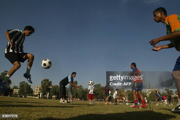 Iraqi players from a local team practice their skills ahead of a match at a pitch close to the Karada district of Baghdad on May 29, 2008. Iraqis...