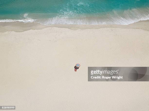 single woman on beach - people aerial view beach stock pictures, royalty-free photos & images
