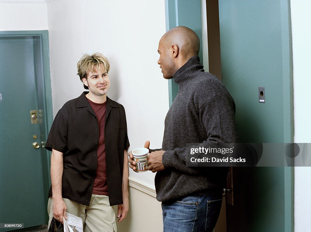 Neighbors chatting in hallway