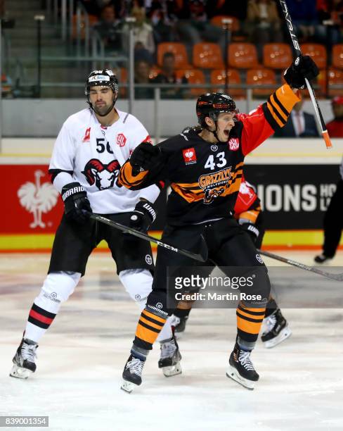 Alexander Weiss of Wolfsburg celebrates after he scores the 4th goal during the Champions Hockey League match between Grizzlys Wolfsburg and HC05...
