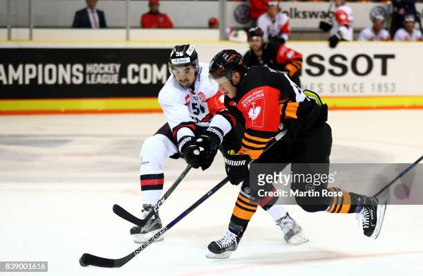 Mark Voakes of Wolfsburg and Vladimir Mihalik of Bystrica battle for the puck during the Champions Hockey League match between Grizzlys Wolfsburg and...