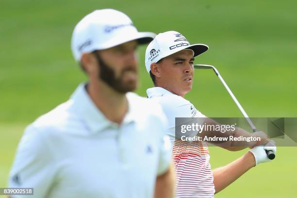 Rickie Fowler and Dustin Johnson of the United States stand on the eighth hole during round two of The Northern Trust at Glen Oaks Club on August 25,...