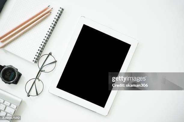 top view office working desk with headphone notepad and tablet ,keyboard and sunglasses relaxing drink with coffee cup and roasted coffee seed - coffee drink on white stock pictures, royalty-free photos & images