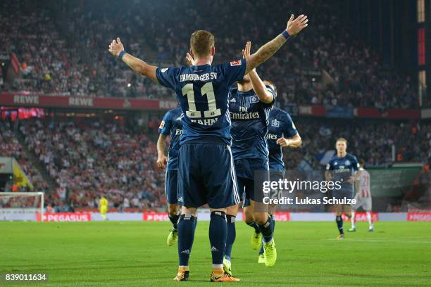 Andre Hahn of Hamburg celebrates with team mates after he scored his teams first goal during the Bundesliga match between 1. FC Koeln and Hamburger...