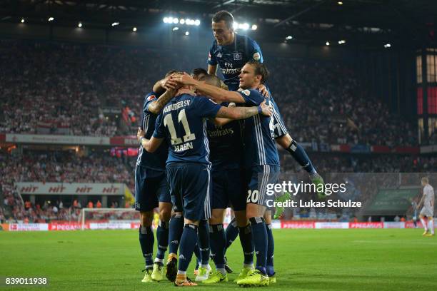 Andre Hahn of Hamburg and Filip Kostic of Hamburg celebrate with team mates after Hahn scored his teams first goal during the Bundesliga match...