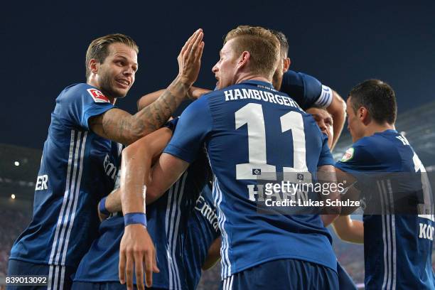Bobby Wood of Hamburg is being celebrated by his team mates Dennis Diekmeier of Hamburg and Andre Hahn of Hamburg after he scored Hamburg's second...