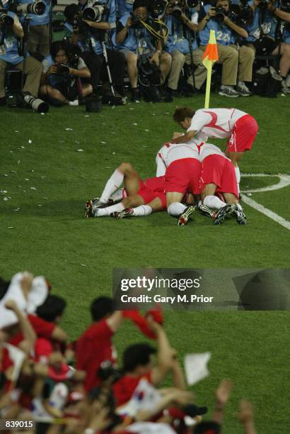South Korea players congratulate team-mate Hyeon Ki Seol after he scored a late equaliser during the FIFA World Cup Finals 2002 Second Round match...