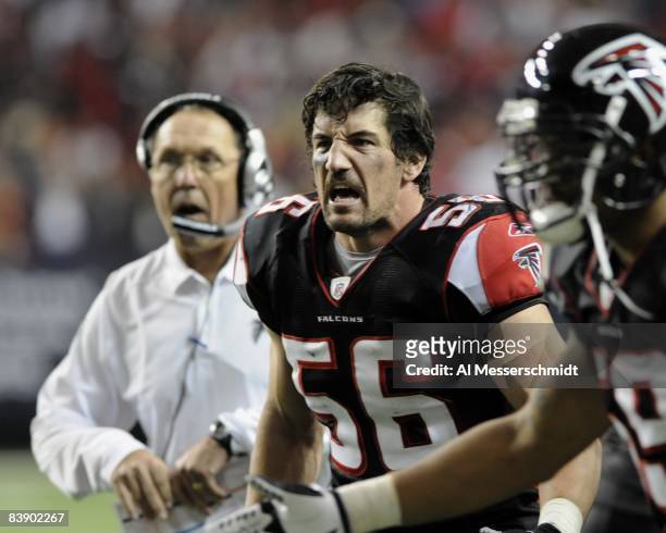 Linebacker Keith Brooking of the Atlanta Falcons cheers a defensive play against the Carolina Panthers at the Georgia Dome on November 23, 2008 in...
