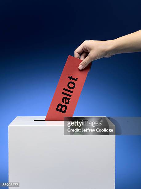 woman placing ballot in ballot box - election ballot stock pictures, royalty-free photos & images