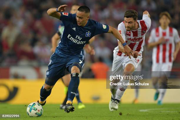 Bobby Wood of Hamburg with Jonas Hector of Koeln during the Bundesliga match between 1. FC Koeln and Hamburger SV at RheinEnergieStadion on August...