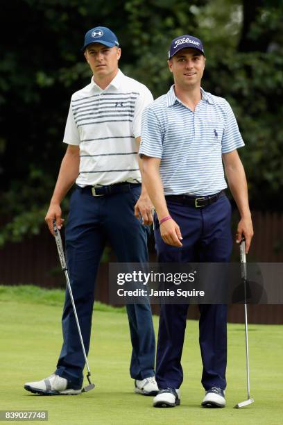 Jordan Spieth and Justin Thomas of the United States stand on the tenth green during round two of The Northern Trust at Glen Oaks Club on August 25,...