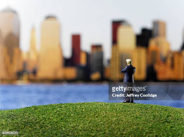 toy businessman looking at city - figurine bildbanksfoton och bilder