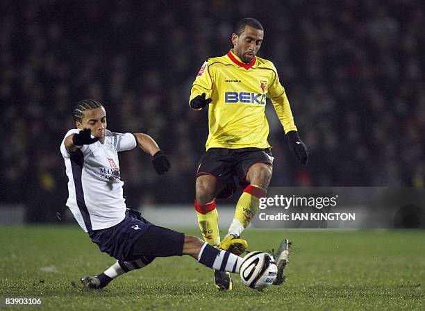 Tottenham Hotspurs Cameroonian defender Benoit Assou-Ekotto challenges Watford's Jamaican striker Lee Williamson during their Carling Cup Quarter...
