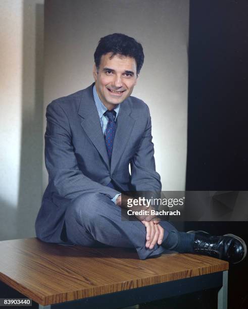 Portrait of American lawyer and consumer advocate Ralph Nader as he sits on a desk facing the camera. He has run several times as the presidential...