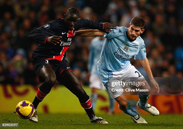 Sakho Mamadou of Paris Saint Germain battles for the ball with Ched Evans of Manchester City during the UEFA Cup Group A match between Manchester...