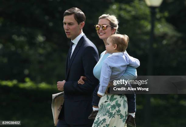 Ivanka Trump walks with husband Jared Kushner and son Theodore James Kushner towards the Marine One on the South Lawn of the White House prior to a...