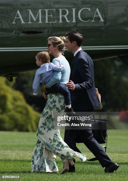 Ivanka Trump walks with husband Jared Kushner and son Theodore James Kushner towards the Marine One on the South Lawn of the White House prior to a...