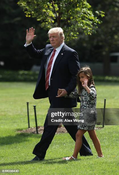 President Donald Trump walks with granddaughter Arabella Rose Kushner towards the Marine One on the South Lawn of the White House prior to a...