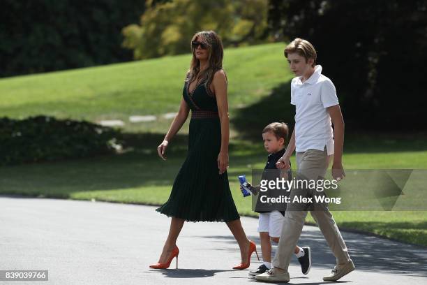 First lady Melania Trump walks with son Barron , and grandson Joseph Frederick Kushner towards the Marine One on the South Lawn of the White House...