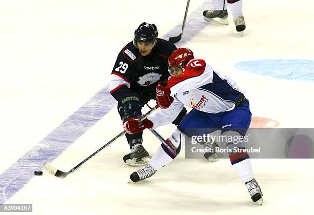 Jens Baxman of EHC Eisbaeren Berlin battles for the puck with Jan Marek of Metallurg Magnitogorsk during the IIHF Champions Hockey League Group A...