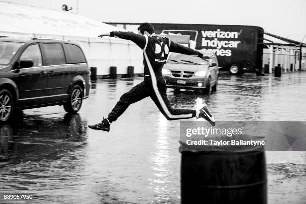Team Penske driver Simon Pagenaud is photographed jumping over a puddle for Sports Illustrated on August 18, 2017 at Pocono Raceway, Verizon IndyCar...