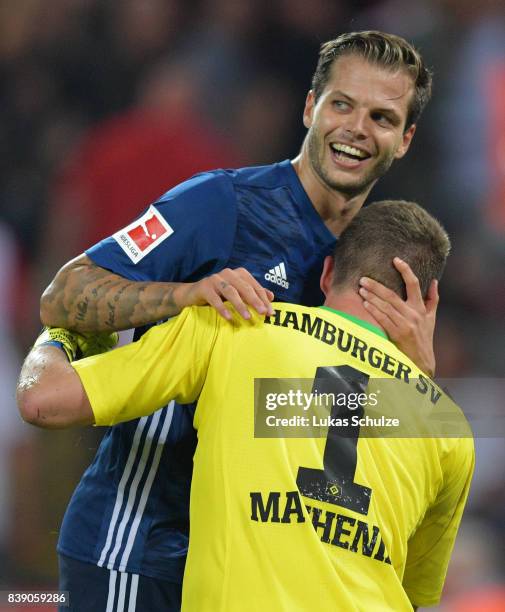 Dennis Diekmeier of Hamburg celebrates with Christian Mathenia of Hamburg after the Bundesliga match between 1. FC Koeln and Hamburger SV at...