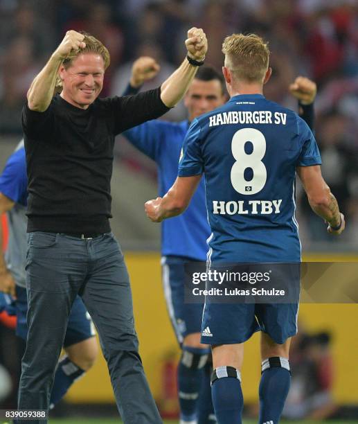 Markus Gisdol, coach of Hamburg, celebrates with Lewis Holtby of Hamburg after the Bundesliga match between 1. FC Koeln and Hamburger SV at...