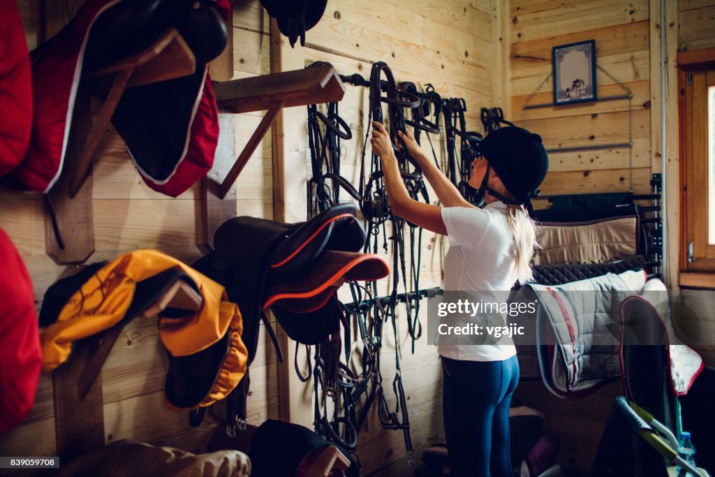 Woman in a barn preparing for training