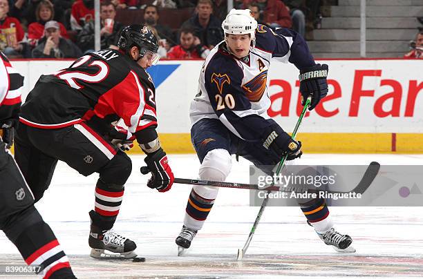 Colby Armstrong of the Atlanta Thrashers stickhandles the puck against Chris Kelly of the Ottawa Senators at Scotiabank Place on December 3, 2008 in...