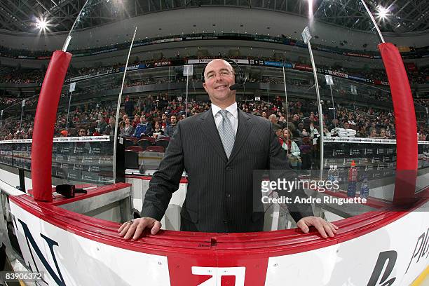S game analyst Pierre McGuire stands at his ice level position between the players' benches prior to a game between the Ottawa Senators and the...