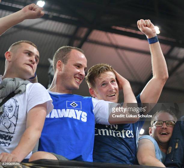 Andre Hahn of Hamburg celebrates with supporters in the stand after the Bundesliga match between 1. FC Koeln and Hamburger SV at RheinEnergieStadion...
